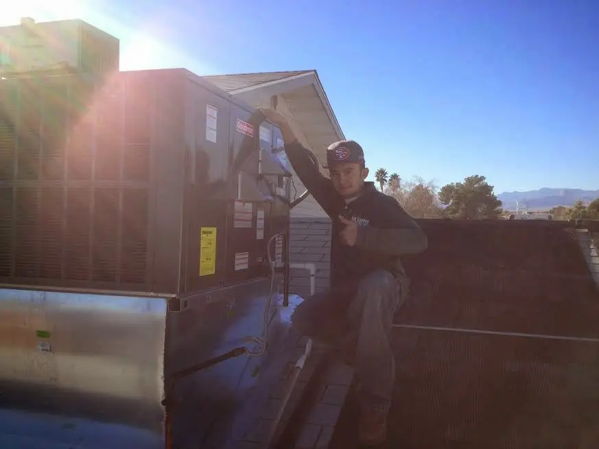 HVAC technician performing HVAC Inspection on a rooftop unit in Mounds View